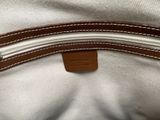 the inside of a white bag with a brown leather handle