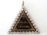 a close up of a triangle shaped pendant with diamonds on it