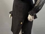 a black dress with sheer sleeves and buttons on a mannequin mannequin mannequin mannequin mannequin mannequin mannequin mann
