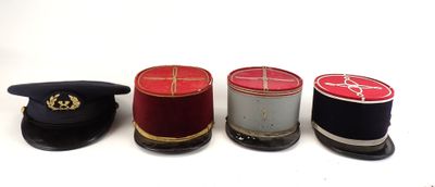 four hats are lined up in a row on a white surface
