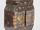 a black and gold box with a bird design on it