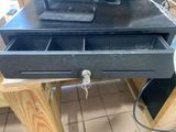 a black drawer with a computer on top of it