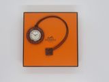 an orange box with a watch on it and a cord around it