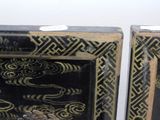 two black and gold boxes with gold designs on them