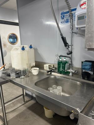 a kitchen with a sink and a counter in it
