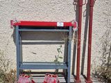 a red fire hydrant sitting next to a red fire hydrant on a wooden platform