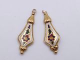 pair of gold and enamel earrings with floral designs on them
