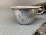 a silver cup and a pair of scissors on a table