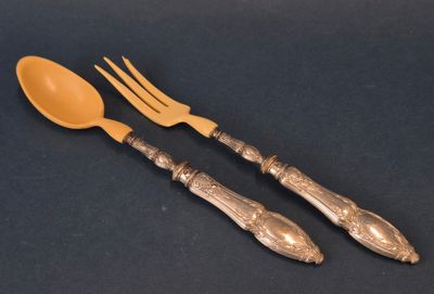 two forks and spoons sitting next to each other on a table