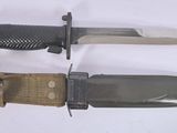 two knives that are laying next to each other on a table