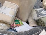 a cart full of bedding and pillows in the store