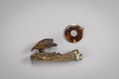 an image of a pair of brooches with a bird on a branch