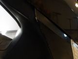 a reflection of a person in the mirror of a car