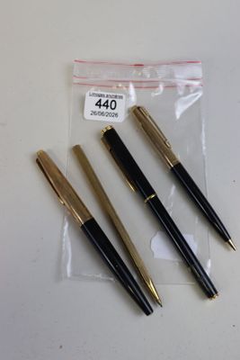 three pens that are sitting in a bag on a table