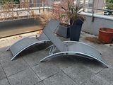 two lounge chairs on the roof of a building