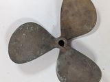 an old propeller propeller on a white surface with a hole in the center