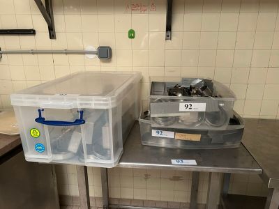 two bins that are sitting on a table in the kitchen