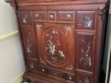a wooden cabinet that has been left in the corner of the room