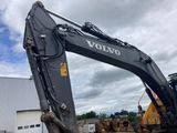 a large black excavator that is sitting in the dirt