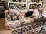 a dog that is laying on a couch in the living room