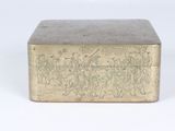 a metal box with a design on it on a white surface