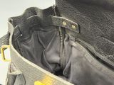 a black purse with a yellow tag on it