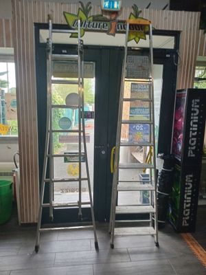two ladders that are standing in front of a door