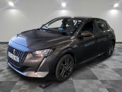 the grey car is parked on a checkered floor in the garage