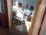 a mirror that is sitting on the floor in a room