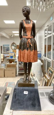a statue of a woman in a dress on a pedestal