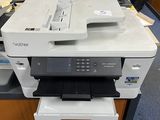 a printer sitting on top of a desk in an office
