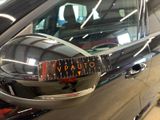 a car that has a sticker on the side mirror of it