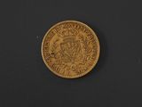 a gold coin with a coat of arms on it