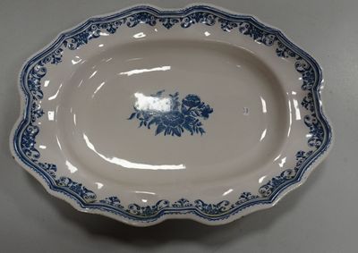 a blue and white plate with a flower design on it