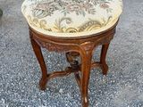 an image of a small stool with a floral upholstered seat