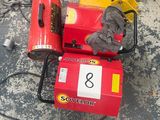 a red and yellow machine that is sitting on the ground