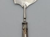 a silver spoon with a metal handle on a table