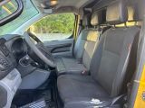 the interior of a yellow van with black seats and a steering wheel