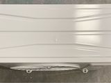 an overhead view of a white plastic box with wheels on a floor