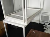 a white desk with a mirror on top of it in a room