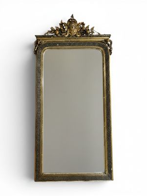 an antique gold framed mirror on a white wall with a white background