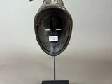 an image of a sculpture of a bird ' s head on a stand