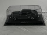 a black car in a clear case on a white surface