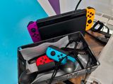 two nintendo wii controllers sitting in a case on a desk