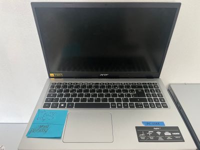 an open laptop computer sitting on top of a desk next to a keyboard
