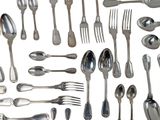 a lot of silver spoons and forks on the table