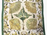 a close up of a green and white scarf with fan design