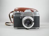 a camera that is sitting on a table with a strap around it