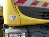 a close up of a yellow truck with a red stripe on it