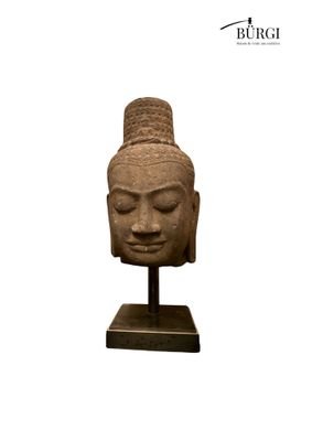 an image of a statue of a head on a stand
